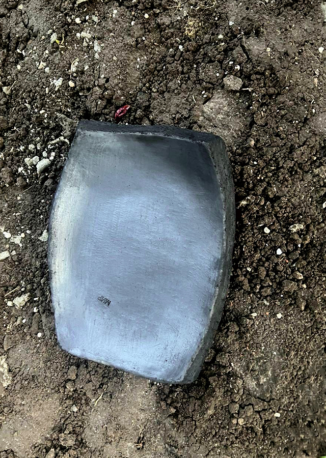 Black clay plate on earth